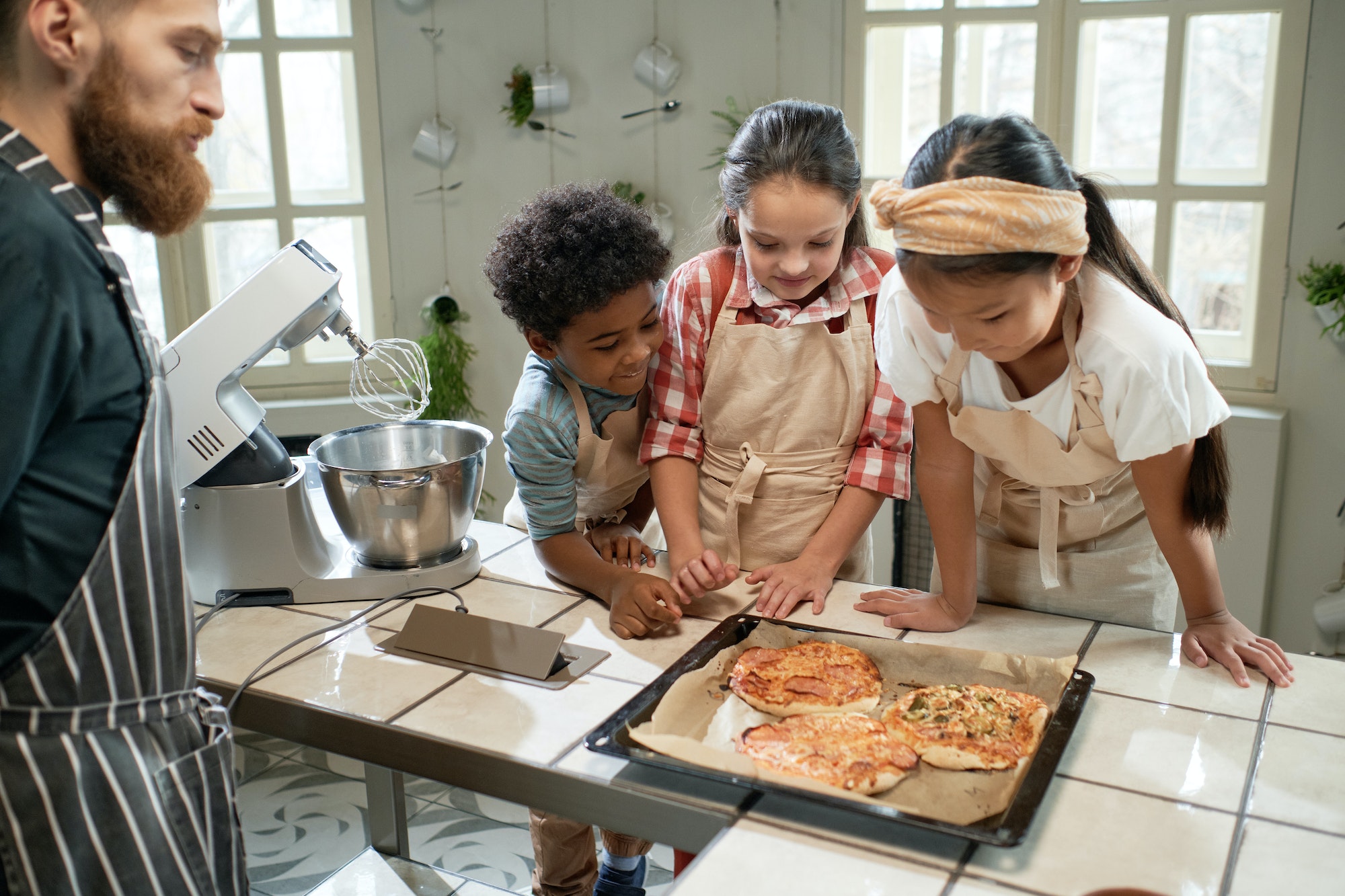 Children making pizza with the chef